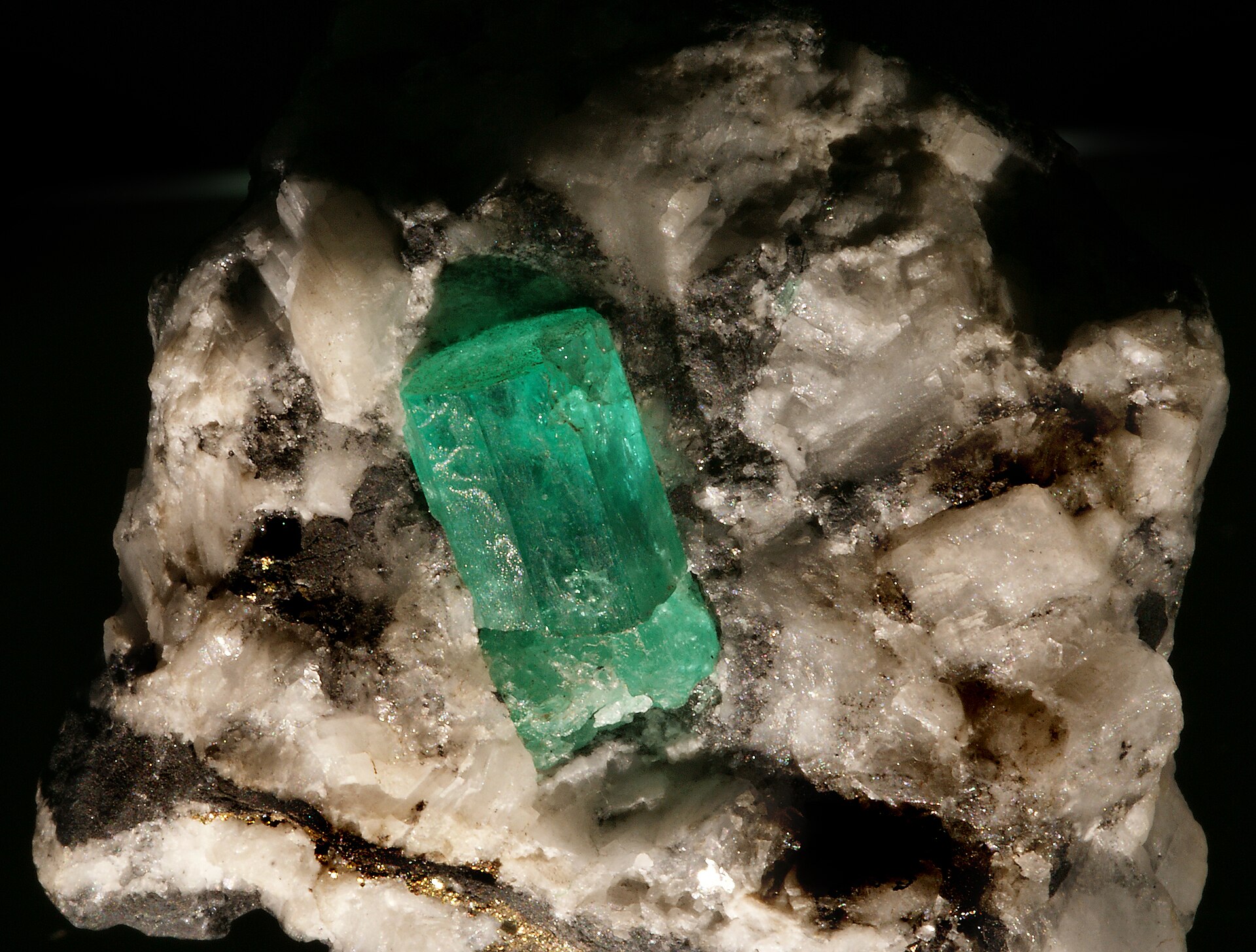 An emerald crystal still in its rock matrix